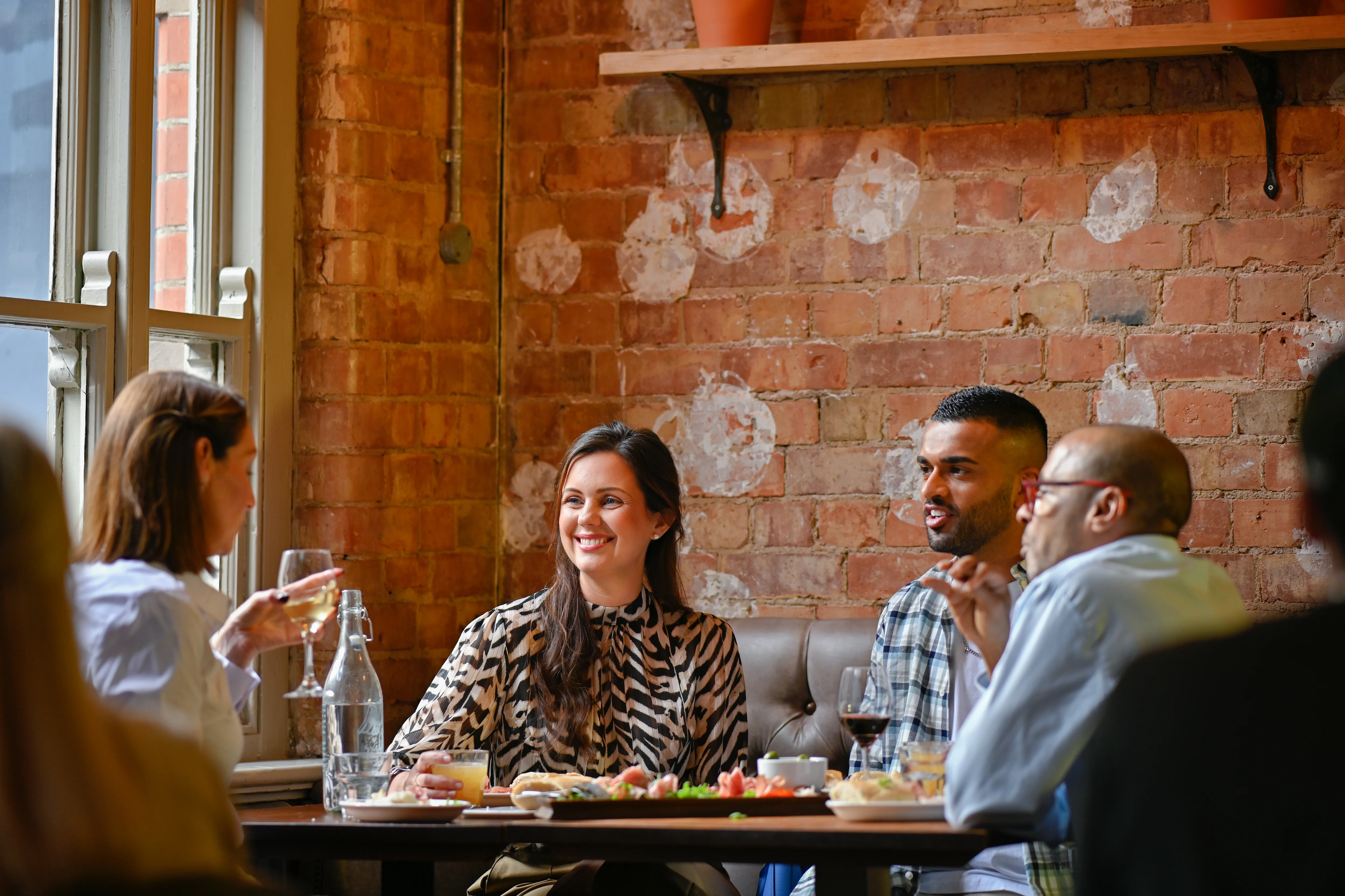 a group of people sitting at a table eating food