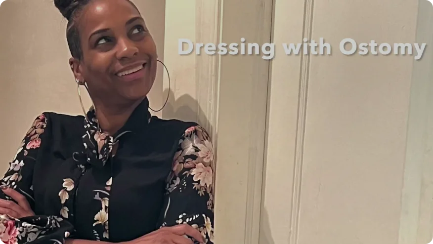 a person smiling and wearing a black dress