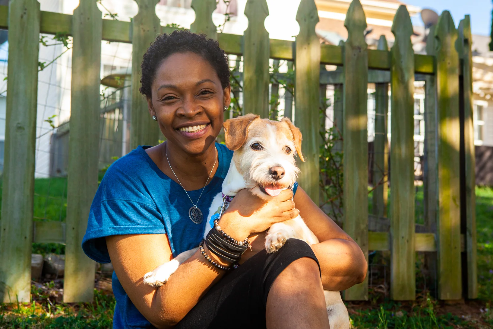 woman smiling holding dog
